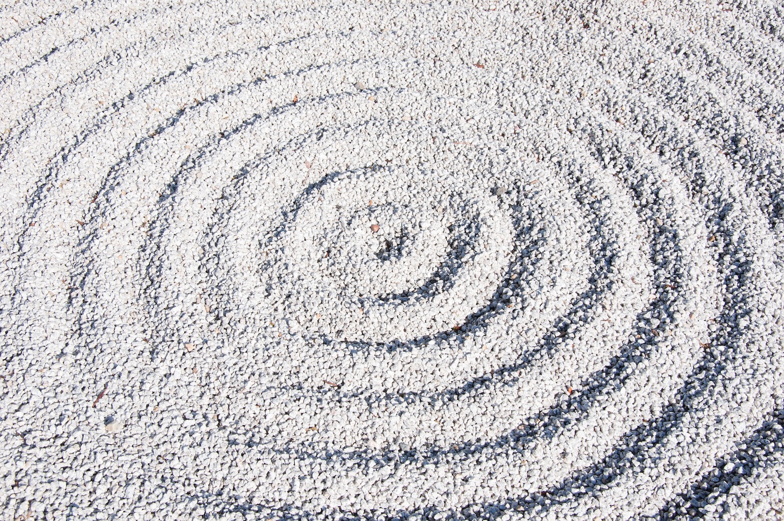 a circular design made of sand on a beach